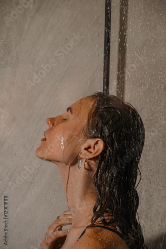 A combination of self-care and sophistication. Water flows over hair and body. Image of hands touching body in the shower. The shine of the rings contrasts beautifully with the water droplets.
