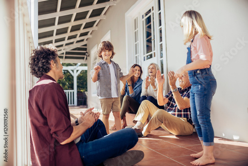 Happy multigenerational family playing together on the porch photo