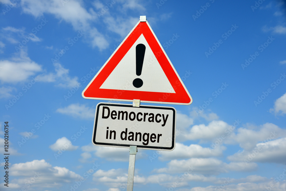 Burgdorf, Lower Saxony, Germany - January 16, 2024: Traffic warning sign saying Democracy in danger Burgdorf, Lower Saxony, Germany - January 16, 2024: Traffic warning sign saying Democracy in danger