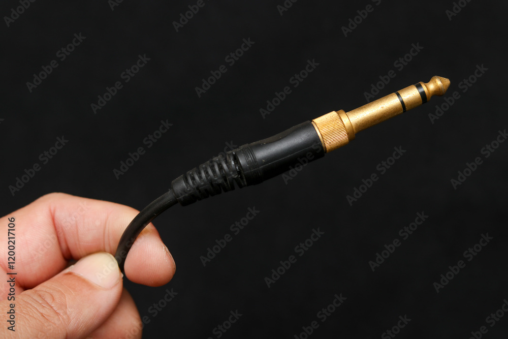 Naklejka premium jack plug audio cable isolated on dark background