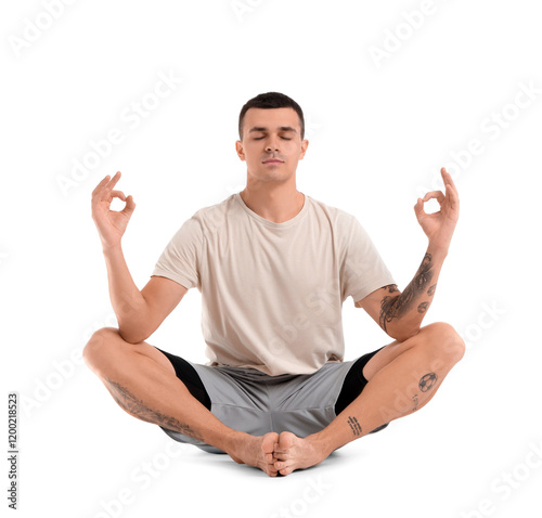 Young man meditating on whi...