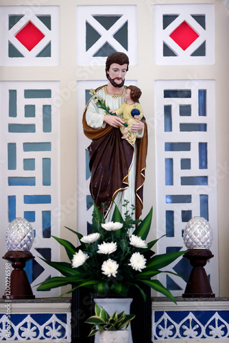 St Francis Xavier, catholic church. Saint Joseph with the  infant Jesus in arm. Hue. Vietnam. photo