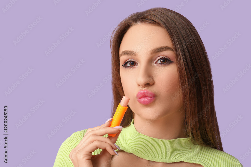 Beautiful young woman applying hygienic lip balm on lilac background Beautiful young woman applying hygienic lip balm on lilac background