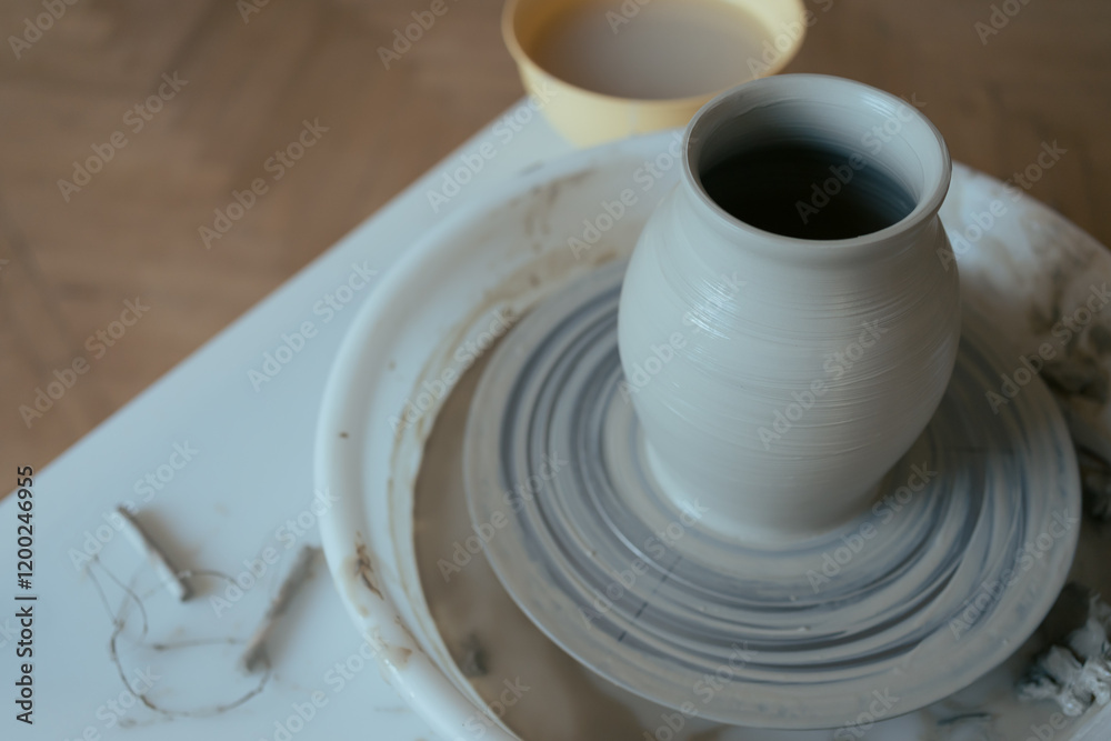 Wet clay vase made by hands on pottery wheel Wet clay vase made by hands on pottery wheel