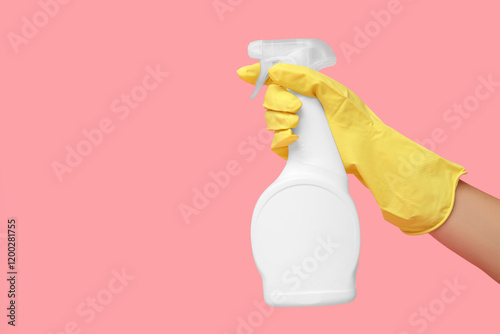 Female hand with mold remover on pink background
