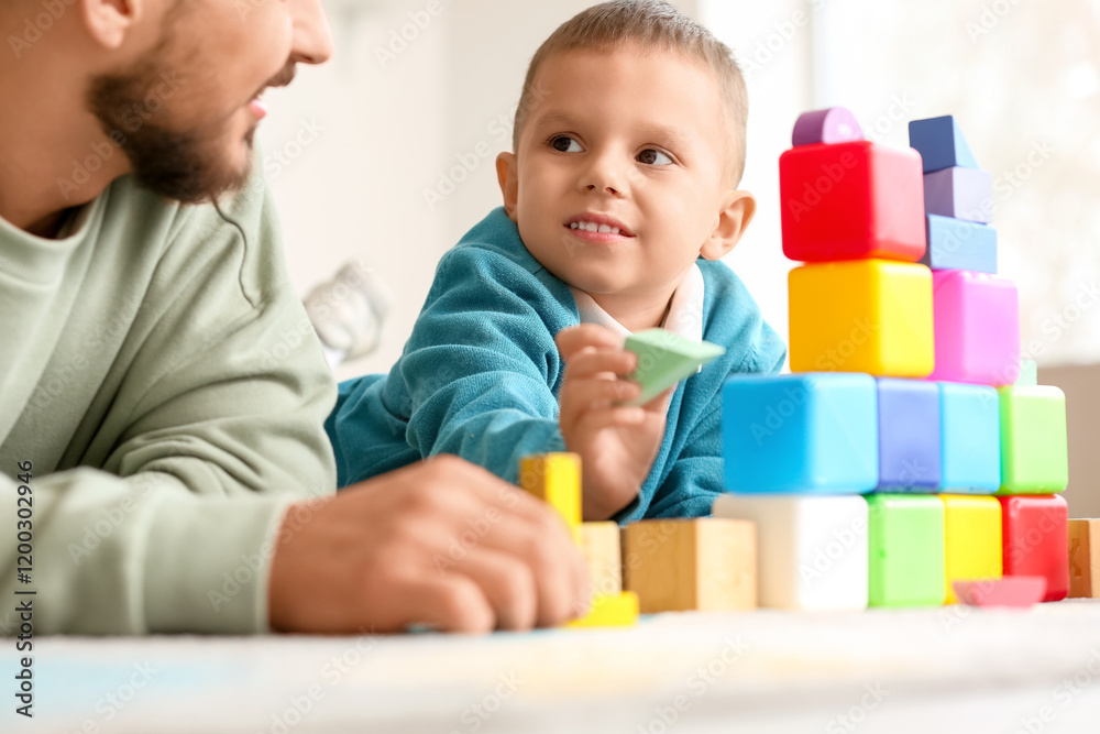 Happy father and his little son playing with colorful cubes at home Happy father and his little son playing with colorful cubes at home