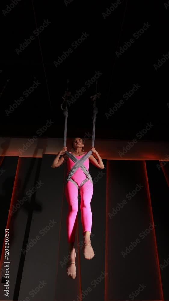 Aerial yoga professional executing graceful suspended poses, demonstrating advanced core strength and precise body balance in minimalist studio setting Aerial yoga professional executing graceful suspended poses, demonstrating advanced core strength and precise body balance in minimalist studio setting