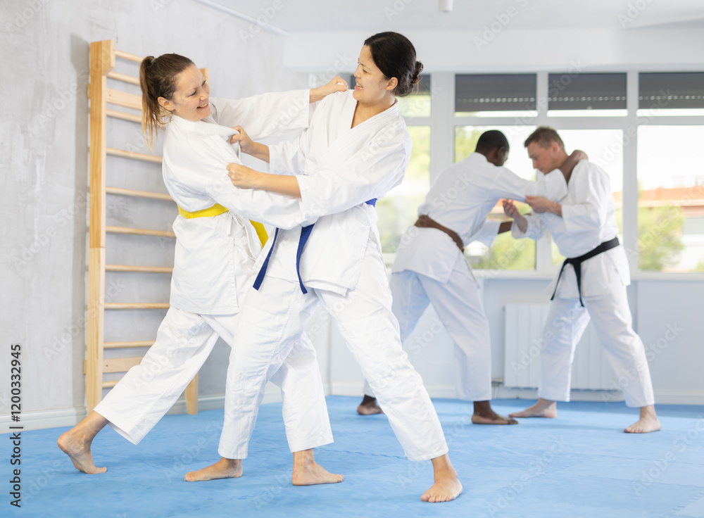 Two female athletes playing Judo in sport hall Two female athletes playing Judo in sport hall