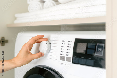 Adjusting settings on an automatic washing machine in a modern laundry room