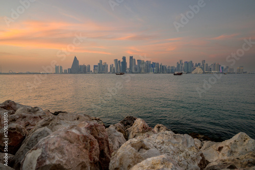 doha qatar skyscrapers by the sea at sunset