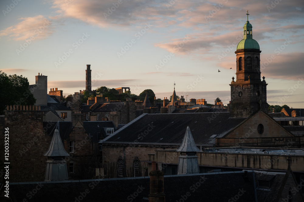 Sunset sky over Edinburgh in the Summer holiday with churches and buildings and a tower. Sunset sky over Edinburgh in the Summer holiday with churches and buildings and a tower.