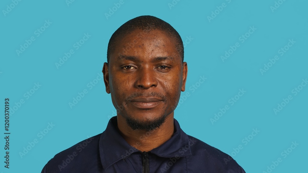 Obraz premium Portrait of security agent celebrating achievements after securing assigned post, studio background. Close up of guardian feeling satisfied after completing tasks, handling security breaches, camera A