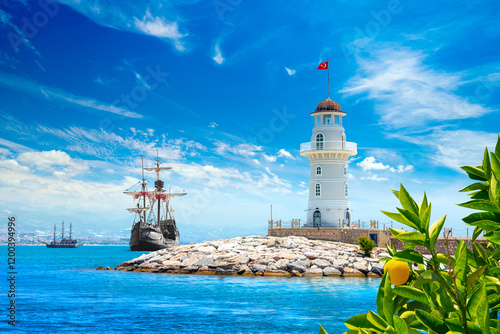 Fototapeta Naklejka Na Ścianę i Meble -  Landscape view with wooden sailing ships and Alanya port lighthouse, Alanya, Turkey