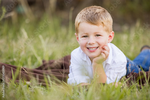 Εκτύπωση καμβά Portrait of little Australian boy lying in grass on farm