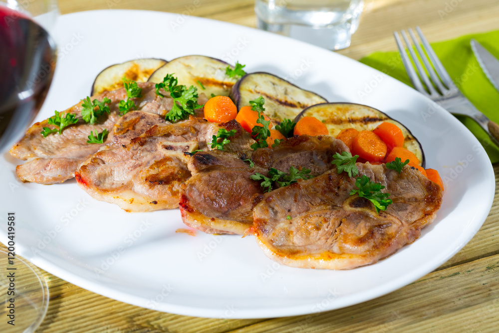 Barbecued lamb chops served with grilled aubergine and carrot Barbecued lamb chops served with grilled aubergine and carrot