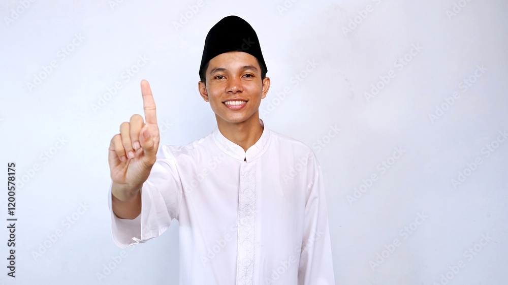 handsome asian muslim young man showing number one using his finger with isolated white background