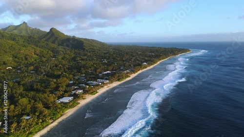 Craggy green coast of Rarotonga, Cook Islands. Aerial at sunset