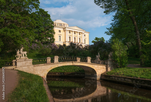 Centaur Bridge over the Slavyanka river against the background of the Pavlovsky Palace in the garden and park reserve Pavlovsky Park  on a sunny summer day,  Pavlovsk, St. Petersburg, Russia photo