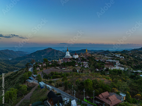 Aerial view amazing Big White Five buddha Statues in sunset. beautiful golden pavilion of Wat Phachonkeaw decorate with jewels and stones on the hill very beautiful and famous landmark in Thailand. photo