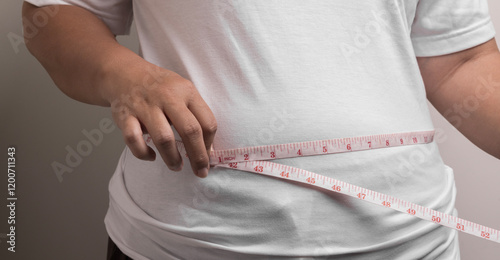 overweight or obese woman shows fat deposits in the abdomen. healthcare, medicine concept. she is dieting and losing weight.