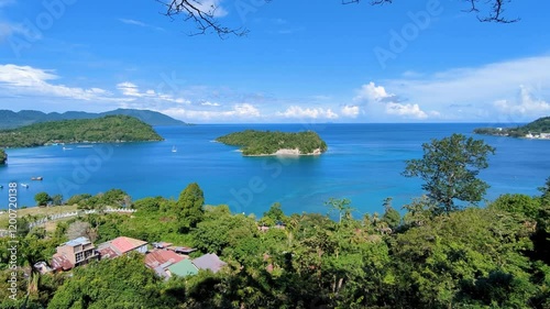 Scenic aerial view on tropical island of Pulau Weh Sabang in Indonesia with blue ocean, idyllic islands, and green tree covered landscape photo