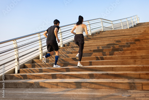Young couple running on the steps