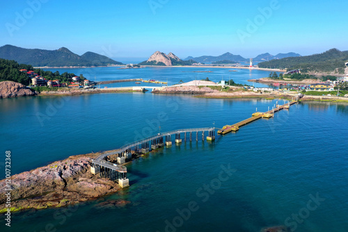 Aerial and summer view of uninhabited rock island with deck trail and bridge on the sea against Jangjado Islands near Seonyudo of Gunsan-si, South Korea photo