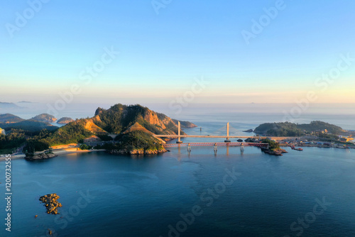 Aerial and sunset view of Skywalk and Jangjagyo Bridge on the sea with Jangjado Island at Seonyudo of Gunsan-si, South Korea photo