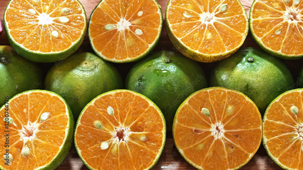 A vibrant assortment of fresh oranges and lemons sliced in half, showcasing their juicy and organic nature against a clean white background A vibrant assortment of fresh oranges and lemons sliced in half, showcasing their juicy and organic nature against a clean white background