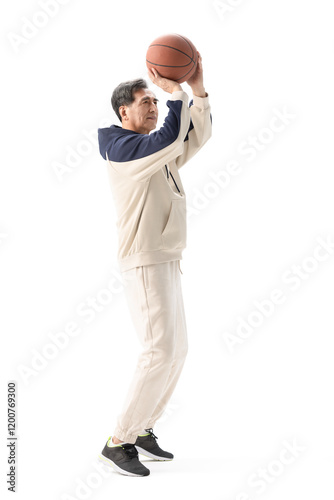 Happy senior man playing basketball photo