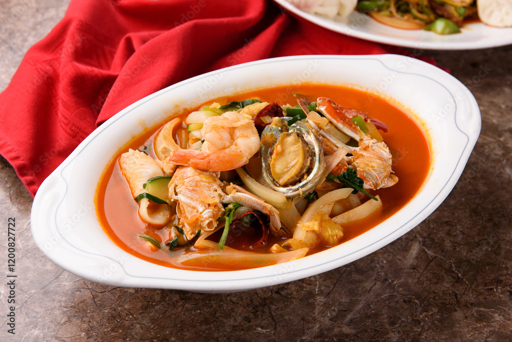 Spicy noodle dish with shrimp, abalone, crab, squid, and vegetables.
Spicy noodle dish with shrimp, abalone, crab, squid, and vegetables.