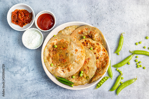 Matar paratha is a delicious Indian flatbread stuffed with spiced mashed green peas, cooked until golden and served with chutney.