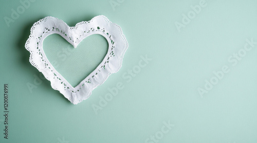 delicate lace doily in shape of heart on mint background