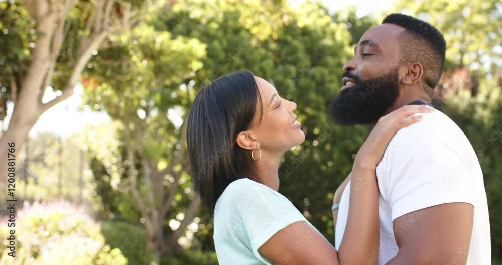 Laughing and embracing, couple enjoying time together in outdoor garden Laughing and embracing, couple enjoying time together in outdoor garden
