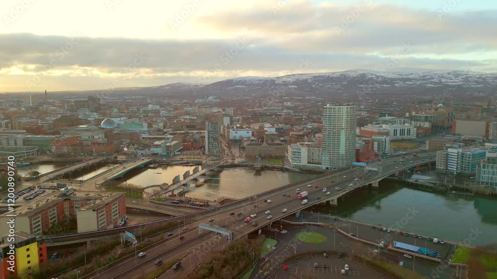 Aerial shot of Belfast City Centre, Northern Ireland on a calm winter day. The camera reverses, showing the city, the River Lagan and cars travelling. Shot in 4K, 60fps and in Rec709 color. Aerial shot of Belfast City Centre, Northern Ireland on a calm winter day. The camera reverses, showing the city, the River Lagan and cars travelling. Shot in 4K, 60fps and in Rec709 color.