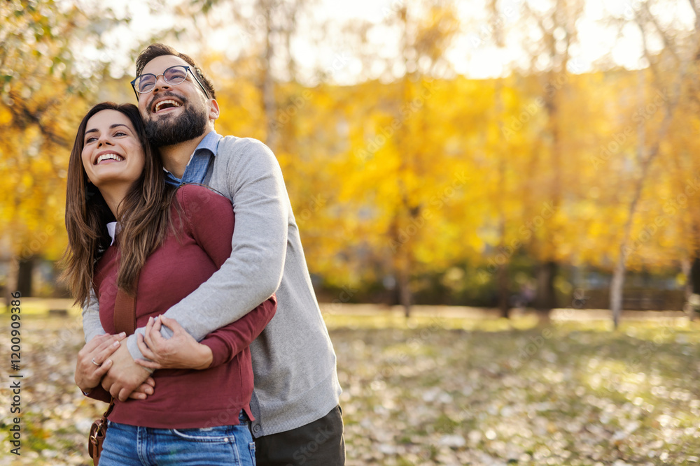 Joyful couple hugging and enjoying togetherness in city park. Copy space. Joyful couple hugging and enjoying togetherness in city park. Copy space.