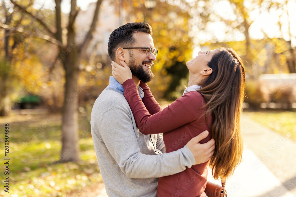Profile of smiling flirty couple hugging outdoors on valentines. Profile of smiling flirty couple hugging outdoors on valentines.