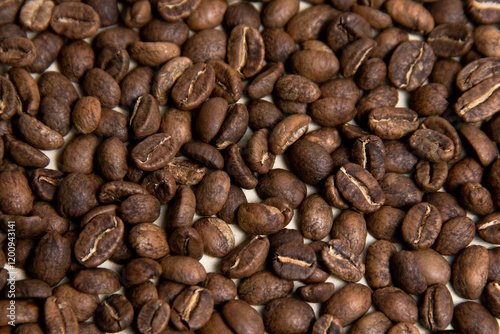 A high-quality photograph of carefully selected coffee beans, showcasing their rich texture and natural colors. Perfect for use as a background in designs, advertisements for coffee shops, cafes, or o