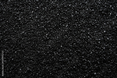 Black background with small particles of sand or dust for a design template, print, and texture