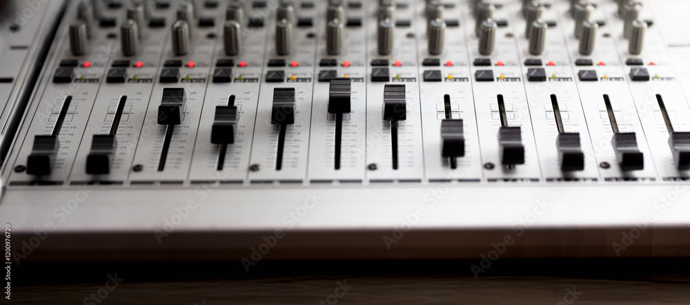 Fototapeta premium Knobs and switches of audio mixer or recording console. Recording background. shallow depth of field.