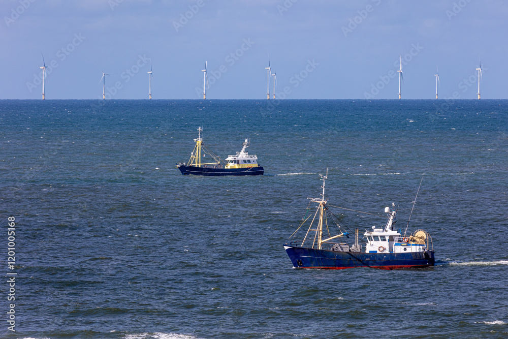 Two fishing vessels in front of an offshore wind park in the North sea near to Egmond aan Zee Two fishing vessels in front of an offshore wind park in the North sea near to Egmond aan Zee