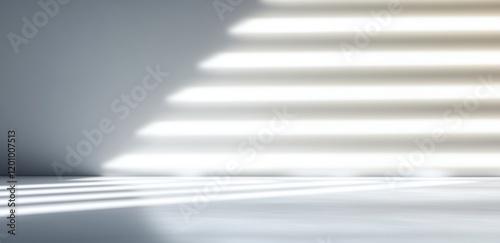 Light beams create striking patterns on a minimalist surface in soft gray tones