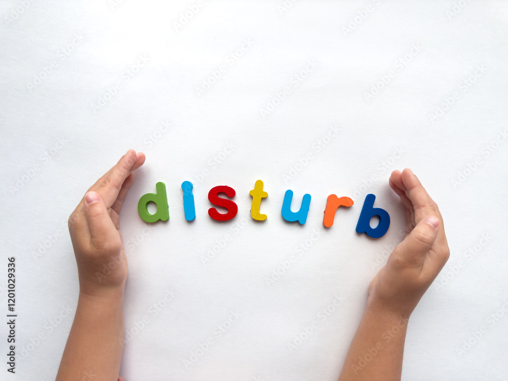 Hands arranging colorful letters spelling disturb on white background