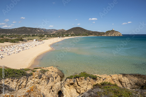 Fototapeta Naklejka Na Ścianę i Meble -  Pula, Italy - 09-10-2024: Beautiful beach in Chia, in Southern Sardinia, with white sand and transparent and turquoise water