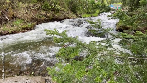 Fast mountain river with pure clear water running among large stones