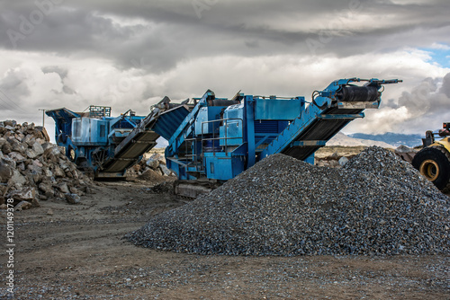 Heavy and mobile machinery in a quarry to transform stone into construction material