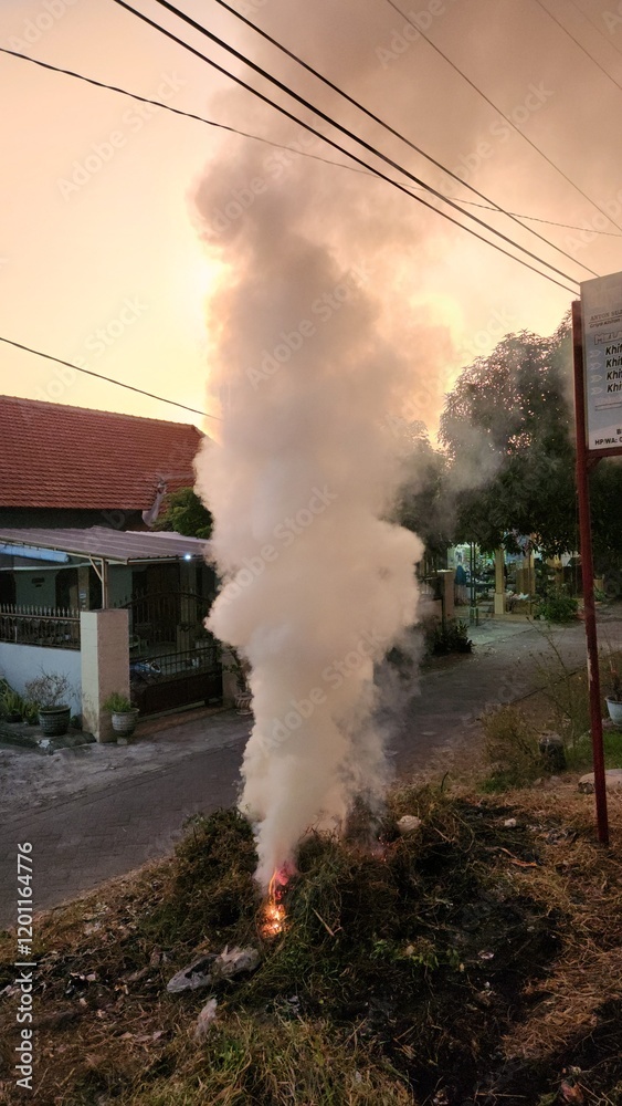 Obraz premium The thick poluttion from people who burnt grass or organic garbages cause health and pedestrian disturbtion, earth damage, and climate change issue