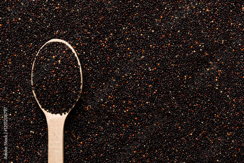 black quinoa grain in wooden spoon background and texture of gluten free top view photo