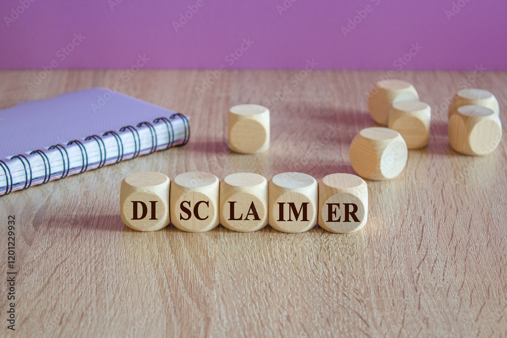 Disclaimer symbol. Writing the word Disclaimer on wooden cubes. Beautiful wooden table, purple background. Notebook. Business concept.