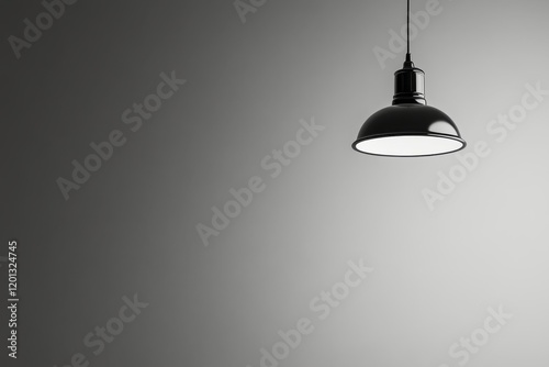 Elegant black pendant lamp hanging against a simple gray background in a mode...
